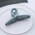 Detail view of large Morandi blue matte cross hair claw clip on white ceramic plate - Matte Cross Light Blue