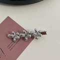 Macro view of silver floral hair clips with white rhinestones on a pink gift card - Silver/White Zirconia-Three Flowers