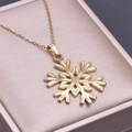 Macro shot of gold snowflake pendant with delicate cross chain on luxury jewelry box - Necklace Set / Gold Color Pendant Necklace