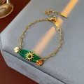 Detail of vintage gold chain bracelet featuring malachite stone and sun motif decoration - Sun Oval Malachite Style (TB70)