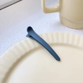 Navy blue matte 8cm duckbill hair clip placed on a minimalist beige ceramic plate - Gray