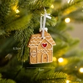 Brown gingerbread house Christmas ornament with white icing and red heart details - Gingerbread House Style B