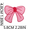 Macro shot of pink embroidered cherry bow patch with detailed stitching and size measurements - Red and Pink Bowknot Style