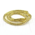 Handcrafted bracelet featuring polished gold metallic hematite disc beads for men - Gold Spacers