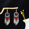 Detail of bohemian dreamcatcher earrings with red beads and silver feather pendants - Red (Dreamcatcher)