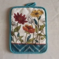 Thick cotton pot holder with colorful floral patterns and blue-green hanging loop - Flower