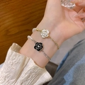 Elegant pearl bracelets with black and white camellia charms on a gold chain - Black Camellia Bracelet (S377 Black) / Black