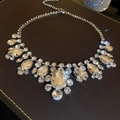 Detailed view of a silver tassel necklace with sparkling teardrop crystals on leather - Silver