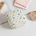 Quilted floral sanitary napkin pouch with colorful dots and a white quilted design - Colored Polka Dots
