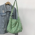Detail of green heart tulip canvas tote bag hanging next to a denim jacket - Green Heart Tulip