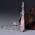 Detail of rose quartz hexagonal pendant with silver floral cap on a rustic wood background - Silver Rose Quartz