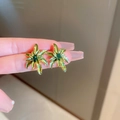 Exquisite green floral stud earrings with gold edges and central green gemstone - Green