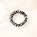 Detail shot of spiral telephone cord hair tie with metallic grey finish on silk fabric - Metallic Gun Black (5cm Thick)