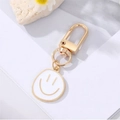Creative mini smiley face keychain with white enamel charm and golden metal hook - White