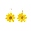Macro detail of handmade raffia sunflower earrings with yellow petals and gold hooks - Yellow
