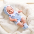 30cm reborn baby doll wearing blue knit pajamas and hat set on a white soft blanket - Blue Knit Romper and Pompom Hat (26)