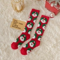 Cozy red plush Christmas socks featuring Santa Claus patterns on a white carpet - Multiple Santas / Knee High