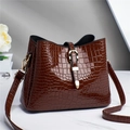 Detail of dark brown faux crocodile leather tote bag with elegant golden clasp lock - Brown