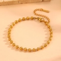 Close-up of golden beaded metal bracelet with lobster clasp and adjustable extension chain - Gold Bracelet