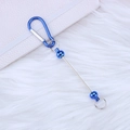 Blue DIY metal carabiner keychain with thin rod and beads on soft white fur background - Blue