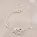 Silver marine charm bracelet featuring blue dolphins and pearls on pink satin - Bright Silver Bracelet (M-300)
