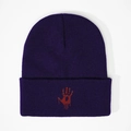 Close-up of deep purple knit beanie featuring a red bloody handprint embroidery design - Navy Blue