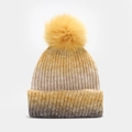 Close-up of thick gradient knit texture and large yellow faux fur pompom on winter beanie - Turmeric and Coffee Gradient