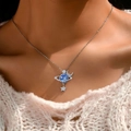 Silver planet necklace with blue orb, moon, and star pendants on a model's neck - Starry Globe (762)