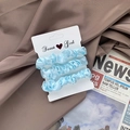 Set of three light blue satin scrunchies displayed on a card with a vintage backdrop - Sky Blue