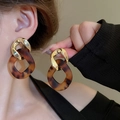 Close-up of leopard print resin earrings with golden metal rings on a model - 25# 925 Sterling Silver Earring Post - Gold Brown - Rhombus