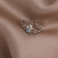 Close-up of vintage crown ring with blue and yellow gems on brown satin fabric - Blue Three-Petal Flower (Silver) (21701D)