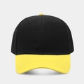 Detail of a two-tone baseball cap featuring black crown and yellow brim with embroidery holes - Black + Yellow Brim