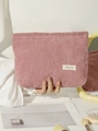 Close-up of pink corduroy makeup bag held by a model for travel and storage - Smoky Pink