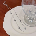Elegant silver snowflake titanium steel necklace displayed on a white ceramic plate - X571 Silver Multi Snowflakes