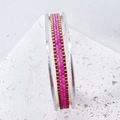Detail view of pink and gold handmade woven beaded bracelet on an acrylic display - Pink