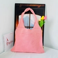 Pink knitted tote bag with woven heart patterns displayed with tulip flowers - Pink