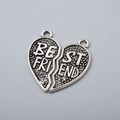 Detailed view of silver metal heart-shaped pendant with Best Friend engraving detail - Antique Silver Best Friend Heart