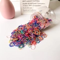 Colorful high-elastic kids hair bands pouring from a clear jar in a bulk pack - Thin Rainbow Series (Approx. 1500 Pcs)
