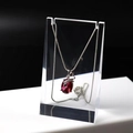 Detail of red oval gemstone pendant on silver chain hanging on acrylic display stand - Medium Transparent 6*3*10CM
