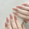 Detail of nude pink ballerina press-on nails with sparkling rhinestone accents - By1691 Pine And Cypress Alliance / Glue Type