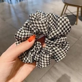 Elegant black and white houndstooth pattern large hair scrunchie held in hand - Black Houndstooth