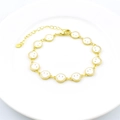 Gold plated lobster clasp bracelet with white enamel smiley face charms on ceramic plate - White