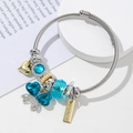 Detail of beaded steel bracelet with blue crystals and handmade golden heart charm - Lake Blue Butterfly