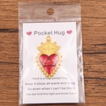 Red enamel Pocket Hug heart charm with gold crown detail on a greeting card - Gold Crown Red Heart