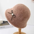 Detail of camel plush bucket hat with black bow and button on a wooden stand - Khaki