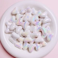 Close-up of white aurora bow beads in a dish for DIY jewelry making material - Sold per piece / White