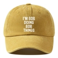 Close-up of mustard yellow washed cotton baseball cap with white printed typography - Adjustable / Yellow
