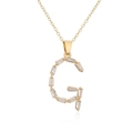 Macro detail of 18K gold plated G letter pendant with baguette cut clear zircons - Letter G