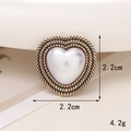 Macro shot of heart-shaped pearl charm with gold metal frame measuring 2.2cm - D1718 Pearl Heart