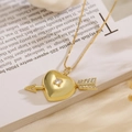 Detail of 18K gold heart pendant with white zircon on an open book background - Heart with Arrow Style (24409) / Gold